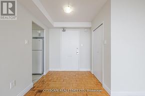 Toronto (Maple Leaf) condo for rent - A white hallway with a wooden floor and a door on the right.