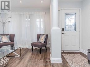 Vaughan (Vellore Village) apartment for rent - A living room with a white door and a glass table.