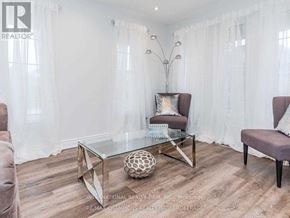 Vaughan (Vellore Village) apartment for rent - A modern living room with a glass coffee table and two chairs.