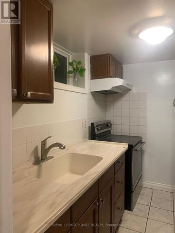 Toronto (Cliffcrest) apartment for rent - A kitchen with a sink and a stove top oven.