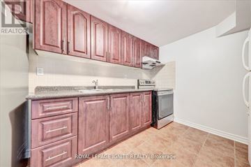 Markham (Middlefield) apartment for rent - A kitchen with brown cabinets and a stainless steel dishwasher.