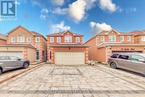 Markham (Middlefield) apartment for rent - A large brick house with a garage and two cars parked in front.