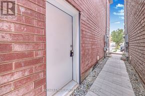 Markham (Middlefield) apartment for rent - A white door with a lock is closed and there is a brick wall on the left.