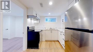 Toronto (Parkwoods-Donalda) apartment for rent - A modern kitchen with a stainless steel refrigerator and wooden flooring.