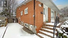 Toronto (Parkwoods-Donalda) apartment for rent - A red brick house with a white door and a black railing.