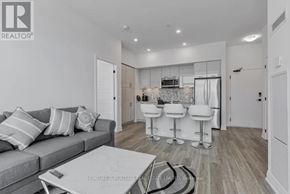 Innisfil condo for rent - A living room with a grey couch and a white coffee table.