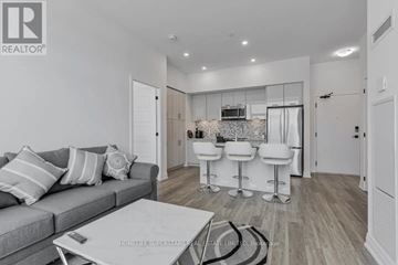 Innisfil condo for rent - A living room with a grey couch and a white coffee table.