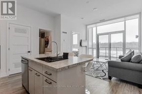 Innisfil condo for rent - A modern kitchen with a marble countertop and a large island.