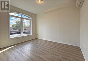 Hamilton (Stinson) apartment for rent - A room with a large window and wooden flooring.