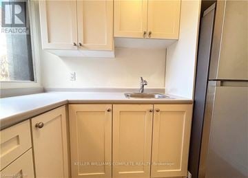 Hamilton (Stinson) apartment for rent - A kitchen with beige cabinets and a sink.