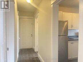 Hamilton (Crown Point) multi-family for rent - A kitchen with white cabinets and a stainless steel refrigerator.
