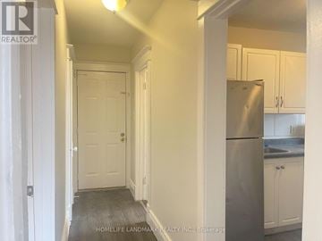 Hamilton (Crown Point) multi-family for rent - A kitchen with white cabinets and a stainless steel refrigerator.
