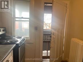Hamilton (Crown Point) multi-family for rent - A small kitchen with a stove and a window.