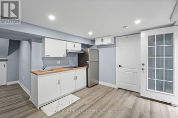 Mississauga (East Credit) apartment for rent - A kitchen with white cabinets and a wooden countertop.