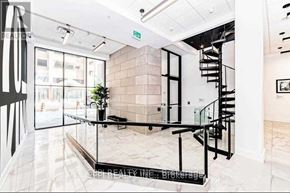 Oshawa (Central) condo for rent - A modern interior space with a spiral staircase and glass walls.