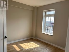 Oshawa (Central) condo for rent - A room with a window and wooden flooring.