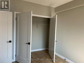 Oshawa (Central) condo for rent - A room with a white door and a white cabinet with a black handle.