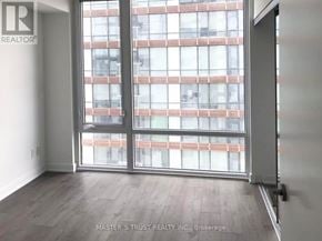 Toronto (Church-Yonge Corridor) condo for rent - A room with a sliding door leading to a balcony with a building in the background.