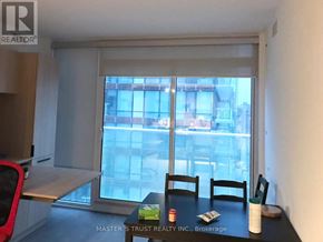 Toronto (Church-Yonge Corridor) condo for rent - A table with a red chair and a black chair in front of a window.