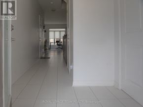 Ottawa townhouse for rent - A white hallway with a logo on the wall and a door on the right.