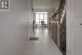 Ottawa townhouse for rent - A hallway with a staircase on the right and a door on the left.