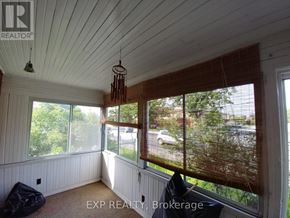 Ottawa apartment for rent - A room with a window covered in a brown mesh.