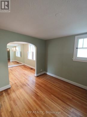 Ottawa apartment for rent - A room with wooden floors and a window.
