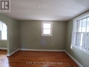 Ottawa apartment for rent - A room with a window and wooden floors.