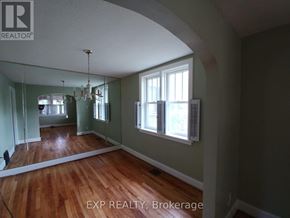 Ottawa apartment for rent - A room with wood floors and a chandelier.