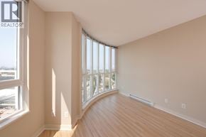 Vancouver apartment for rent - A room with a large window and wooden floors.