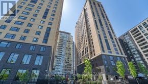 Ottawa condo for rent - A tall building with many windows stands in front of a skyline.