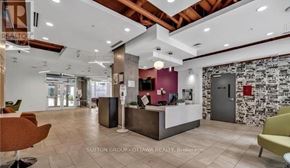 Ottawa condo for rent - A reception area with a white reception desk and a stone wall in the background.