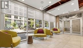 Ottawa condo for rent - A realtor office with yellow chairs and a glass wall.