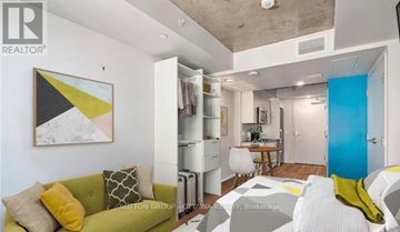 Ottawa condo for rent - A living room with a green couch and a painting on the wall.
