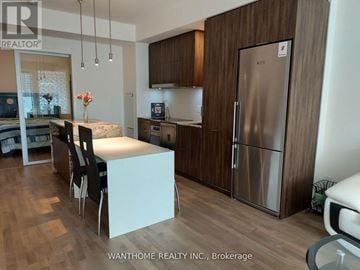 Toronto (Church-Yonge Corridor) condo for rent - A kitchen with a refrigerator, sink, and table.
