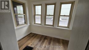 Hamilton (Landsdale) apartment for rent - A room with three windows and a wooden floor.