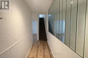 Hamilton (Landsdale) apartment for rent - A hallway with a glass wall on the right side and a wooden floor.