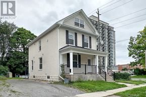 Oshawa (O'neill) duplex for rent - A two-story house with a front porch and a black railing.