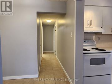 London North (North N) condo for rent - A kitchen area with a stove and a doorway leading to another room.