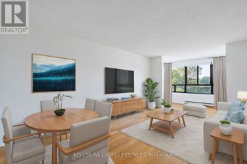 London North (North C) condo for rent - A living room with a wooden table and chairs, a television, and a painting on the wall.