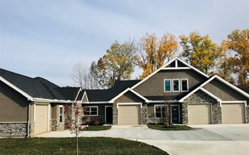 Overland Park apartment for rent - A house with a stone wall and a black door.