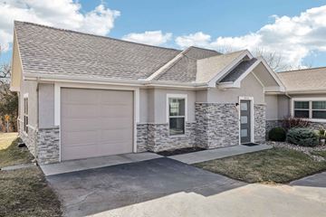 Lenexa apartment for rent - A two-car garage with a stone facade and a grey roof.
