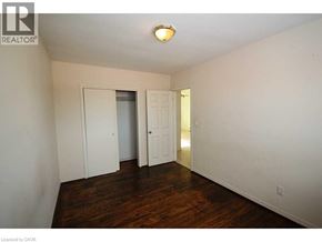 Brantford apartment for rent - A room with a wooden floor and white walls.