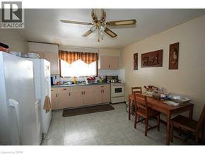 Brantford apartment for rent - A kitchen with a table and chairs in front of it.