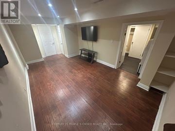 Ajax (Northeast Ajax) apartment for rent - A living room with wood flooring and a flat screen TV.