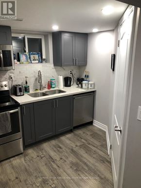 Hamilton (Berrisfield) apartment for rent - A kitchen with a sink, stove, and cabinets.