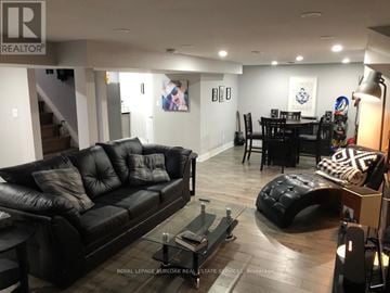 Hamilton (Berrisfield) apartment for rent - A living room with a black leather couch and a coffee table.