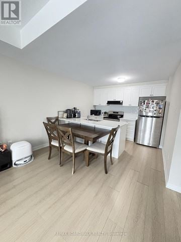Ottawa townhouse for rent - A kitchen with a table and chairs in the middle of the room.