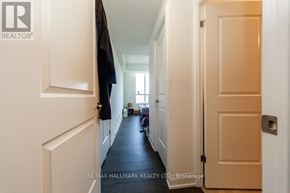 Toronto (Scarborough Village) condo for rent - A hallway with a door on the right and a coat hanging on the wall.