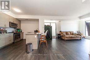 Toronto (Scarborough Village) condo for rent - A modern kitchen with a dining area and a living room.